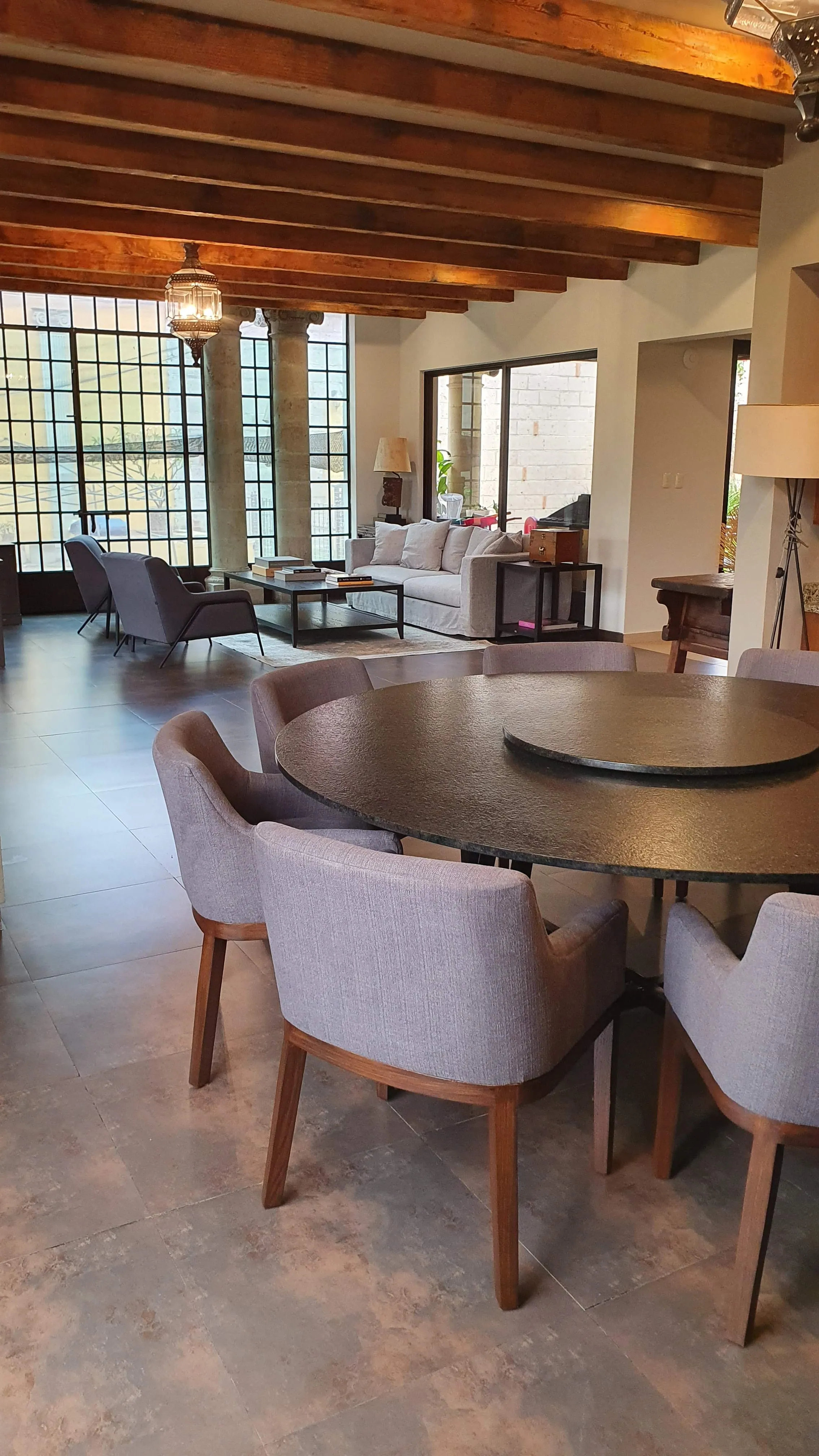 Dining room with granite table and upholstered chairs